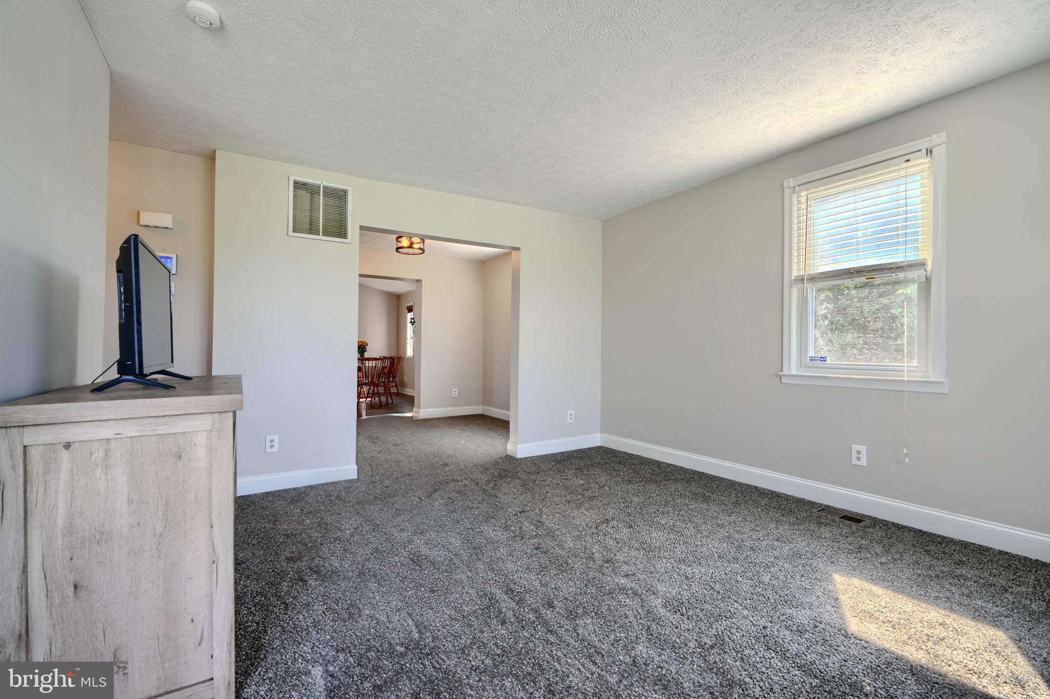 5221 Trumps Mill Road Baltimore, MD 21206 - Photo 11 of 53 a view of empty room with a fireplace and cabinet