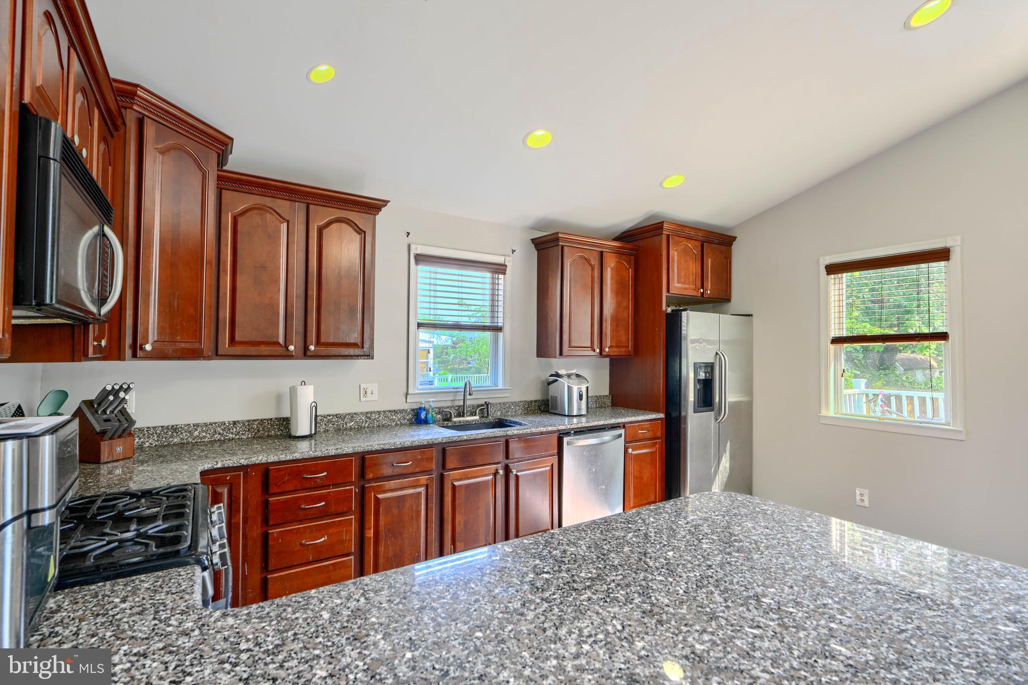5221 Trumps Mill Road Baltimore, MD 21206 - Photo 17 of 53 a kitchen with stainless steel appliances granite countertop a sink stove and refrigerator