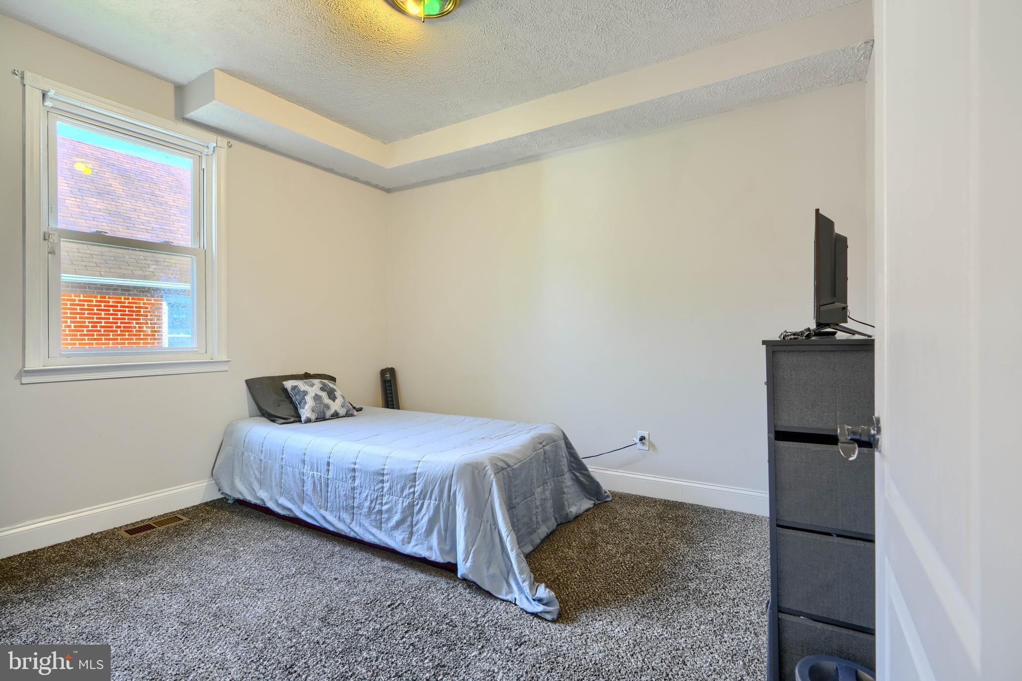 5221 Trumps Mill Road Baltimore, MD 21206 - Photo 18 of 53 a bedroom with a bed and a painting on the wall