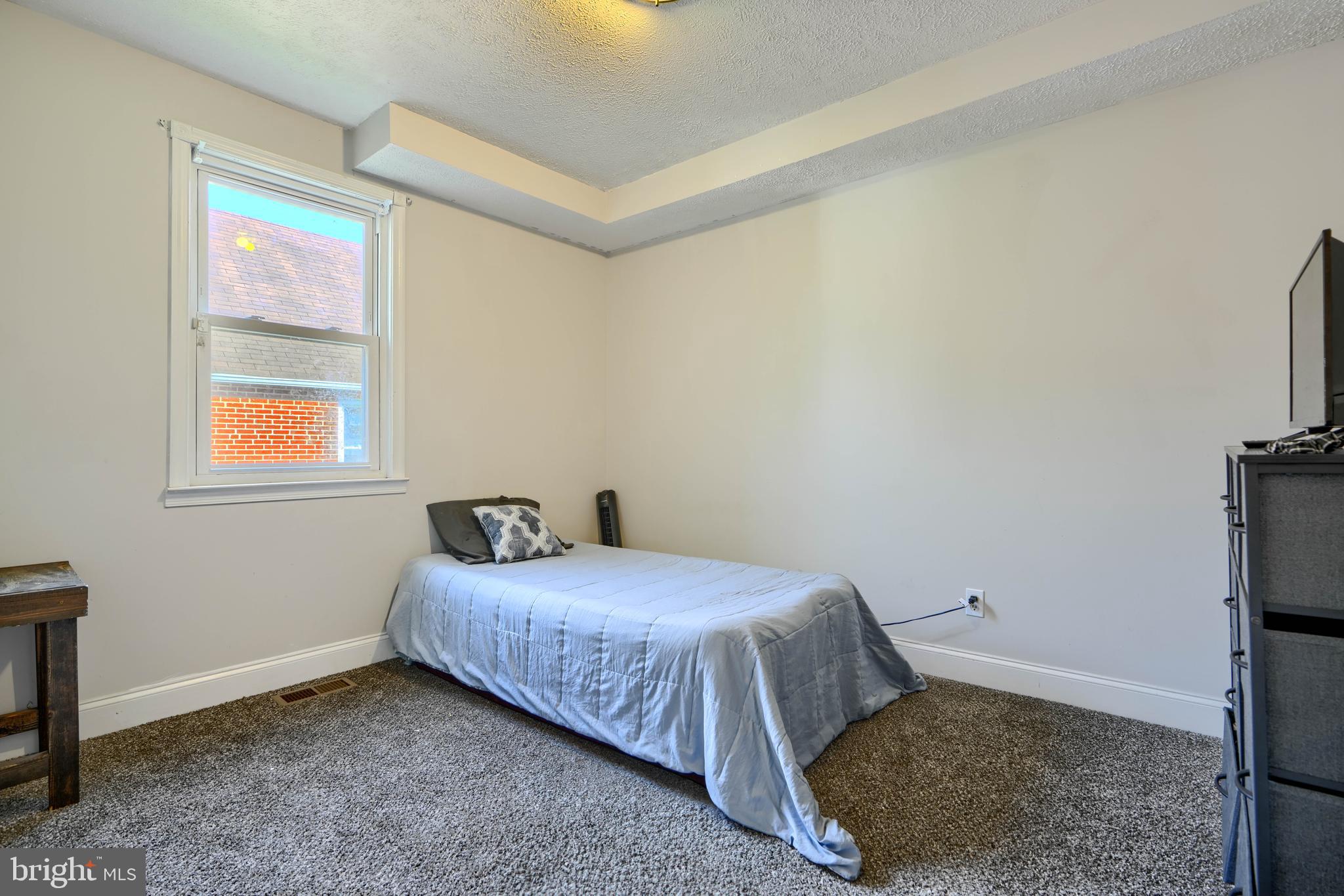 5221 Trumps Mill Road Baltimore, MD 21206 - Photo 19 of 53 a bedroom with a bed and a window