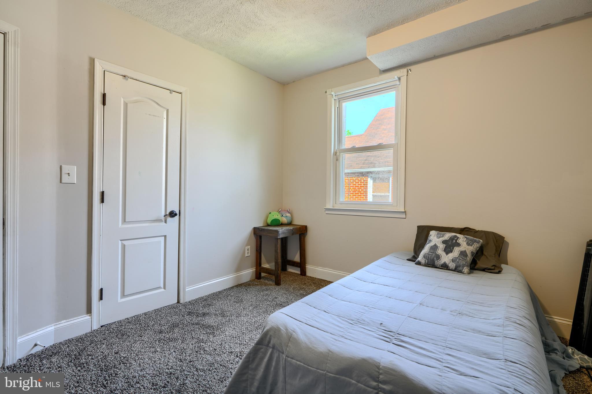 5221 Trumps Mill Road Baltimore, MD 21206 - Photo 20 of 53 a bedroom with a bed and a window