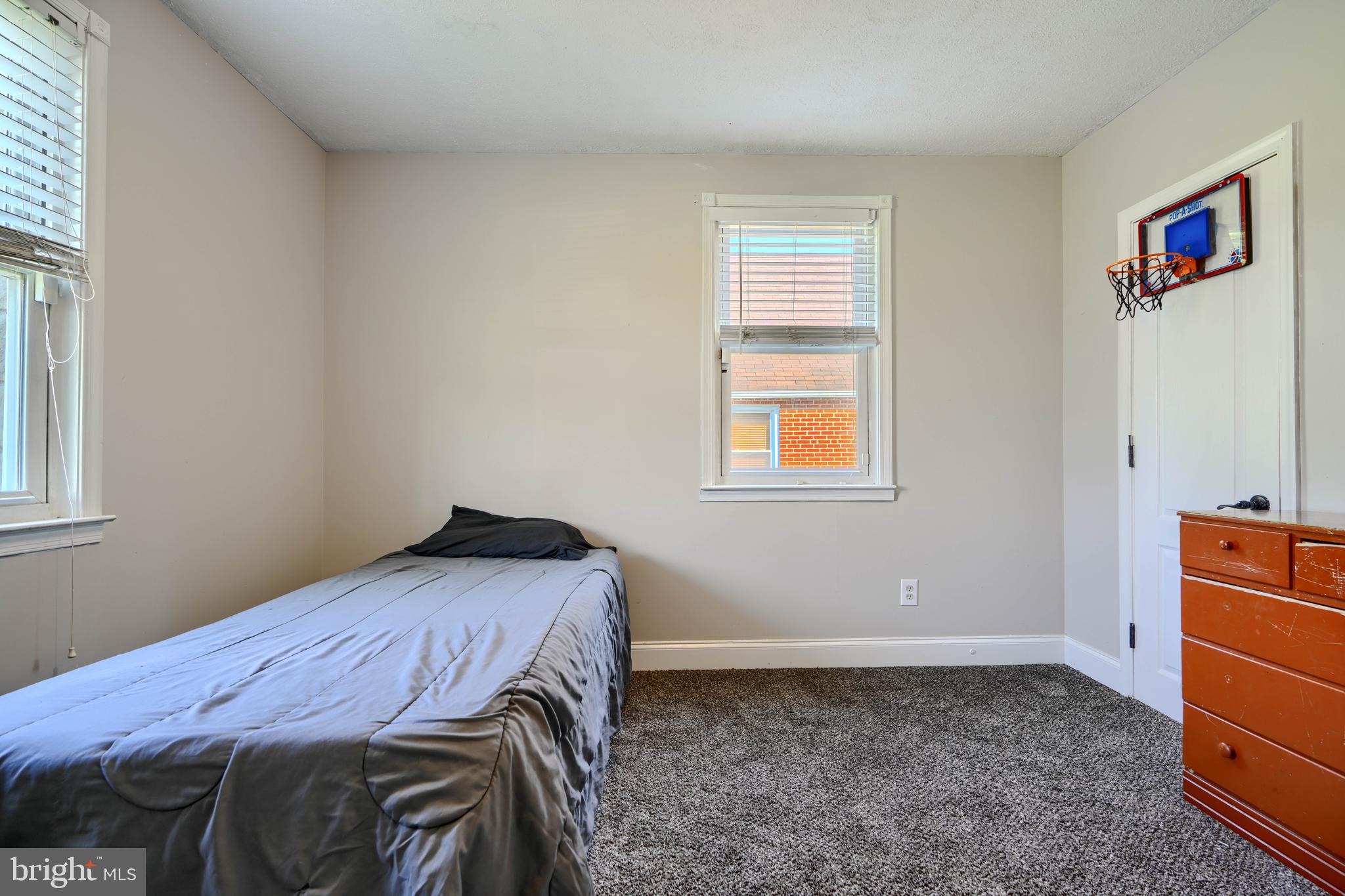 5221 Trumps Mill Road Baltimore, MD 21206 - Photo 23 of 53 a bedroom with a bed and a window