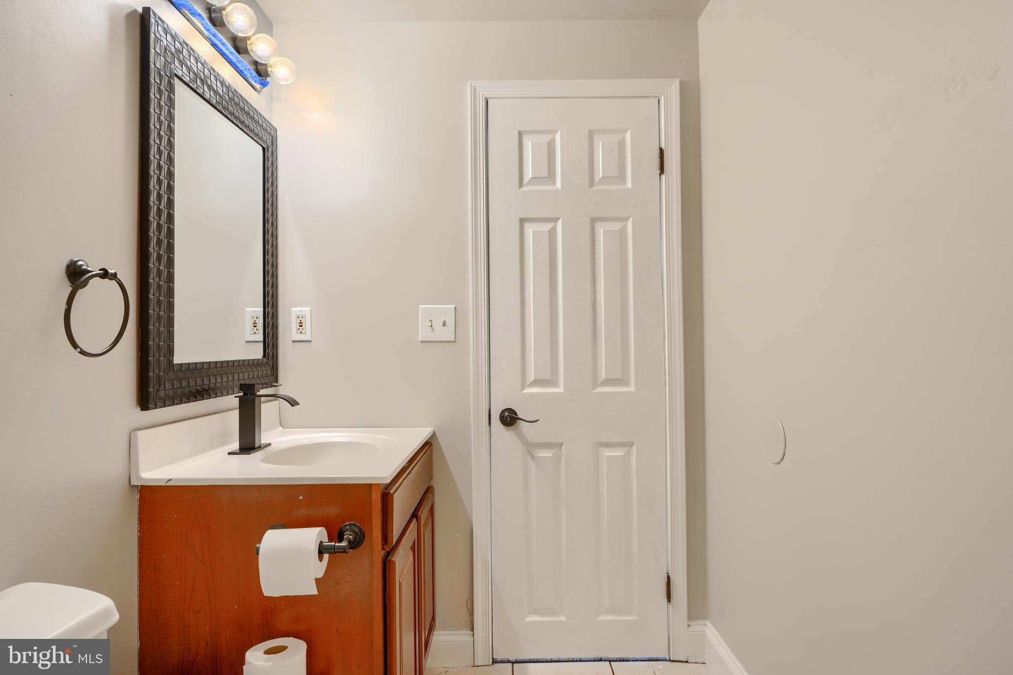 5221 Trumps Mill Road Baltimore, MD 21206 - Photo 25 of 53 a bathroom with a sink and a mirror