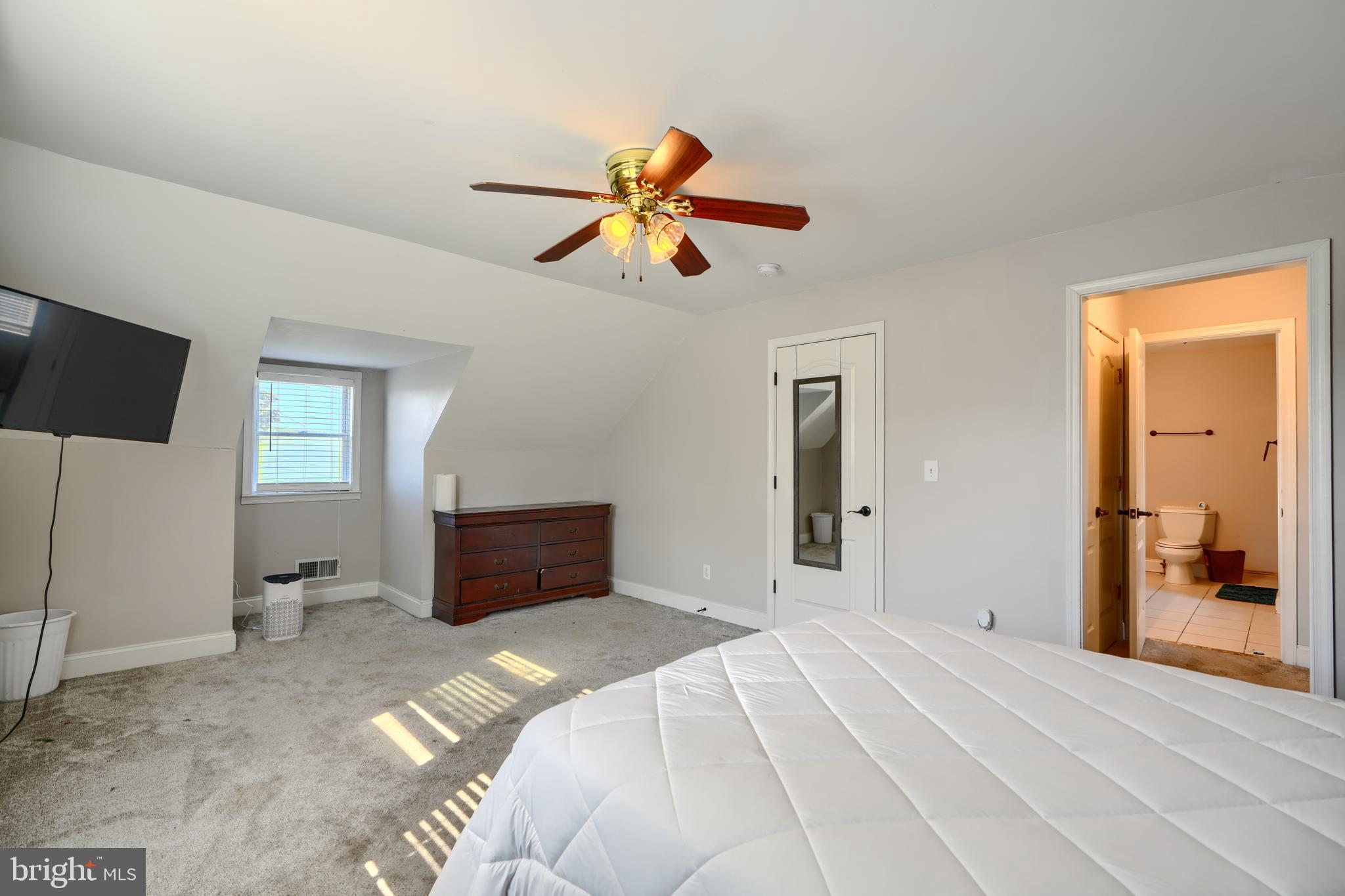 5221 Trumps Mill Road Baltimore, MD 21206 - Photo 28 of 53 a bedroom with a bed and a flat screen tv