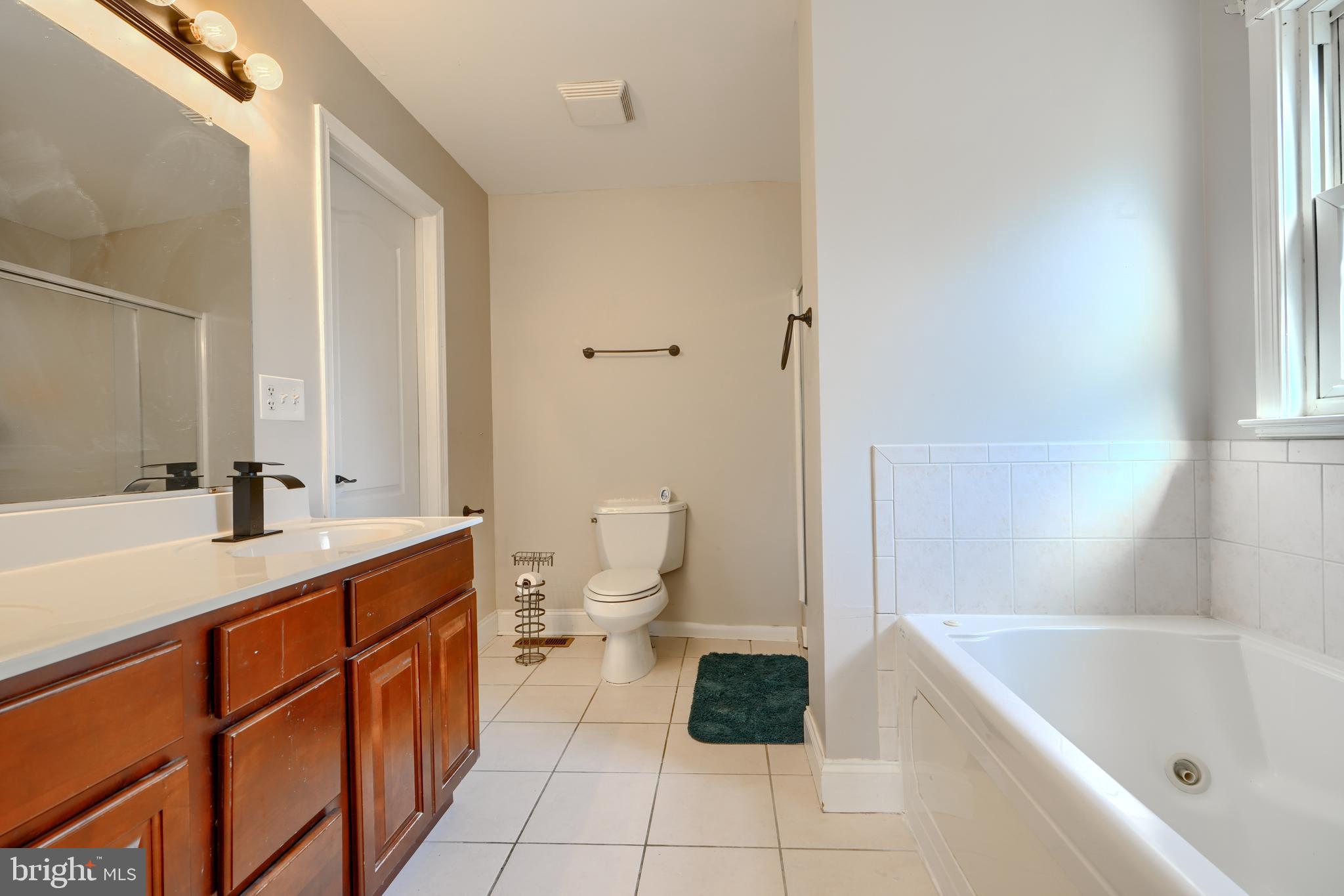 5221 Trumps Mill Road Baltimore, MD 21206 - Photo 30 of 53 a bathroom with a sink a toilet and shower