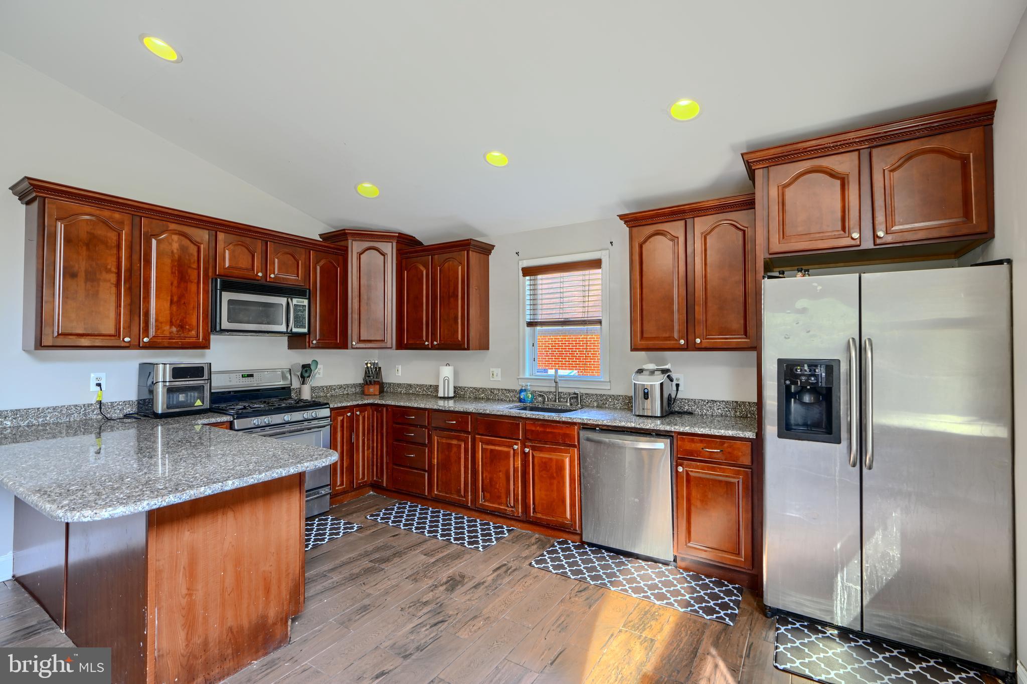 5221 Trumps Mill Road Baltimore, MD 21206 - Photo 3 of 53 a kitchen with stainless steel appliances granite countertop a sink stove and refrigerator