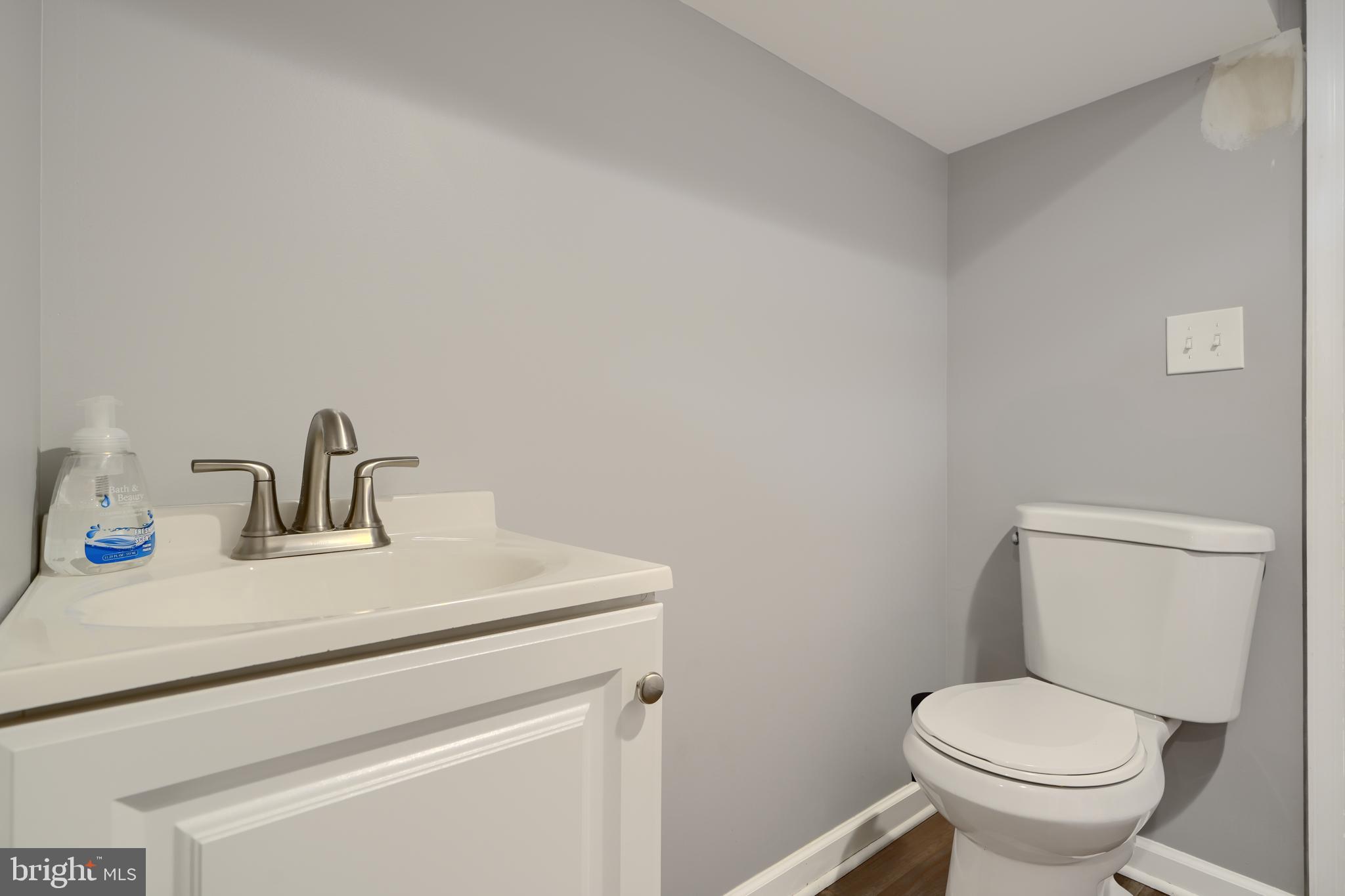 5221 Trumps Mill Road Baltimore, MD 21206 - Photo 38 of 53 a bathroom with a toilet sink and mirror