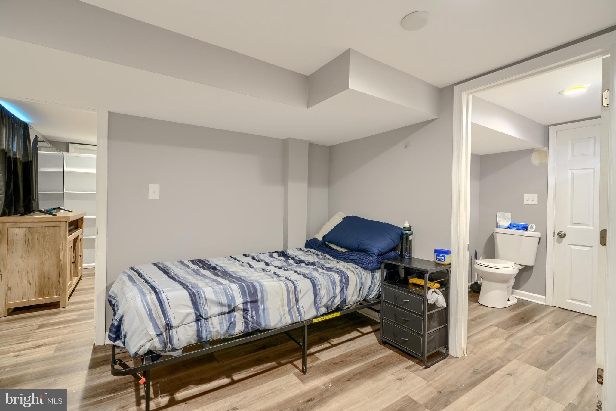 5221 Trumps Mill Road Baltimore, MD 21206 - Photo 39 of 53 a bedroom with a bed and wooden floor