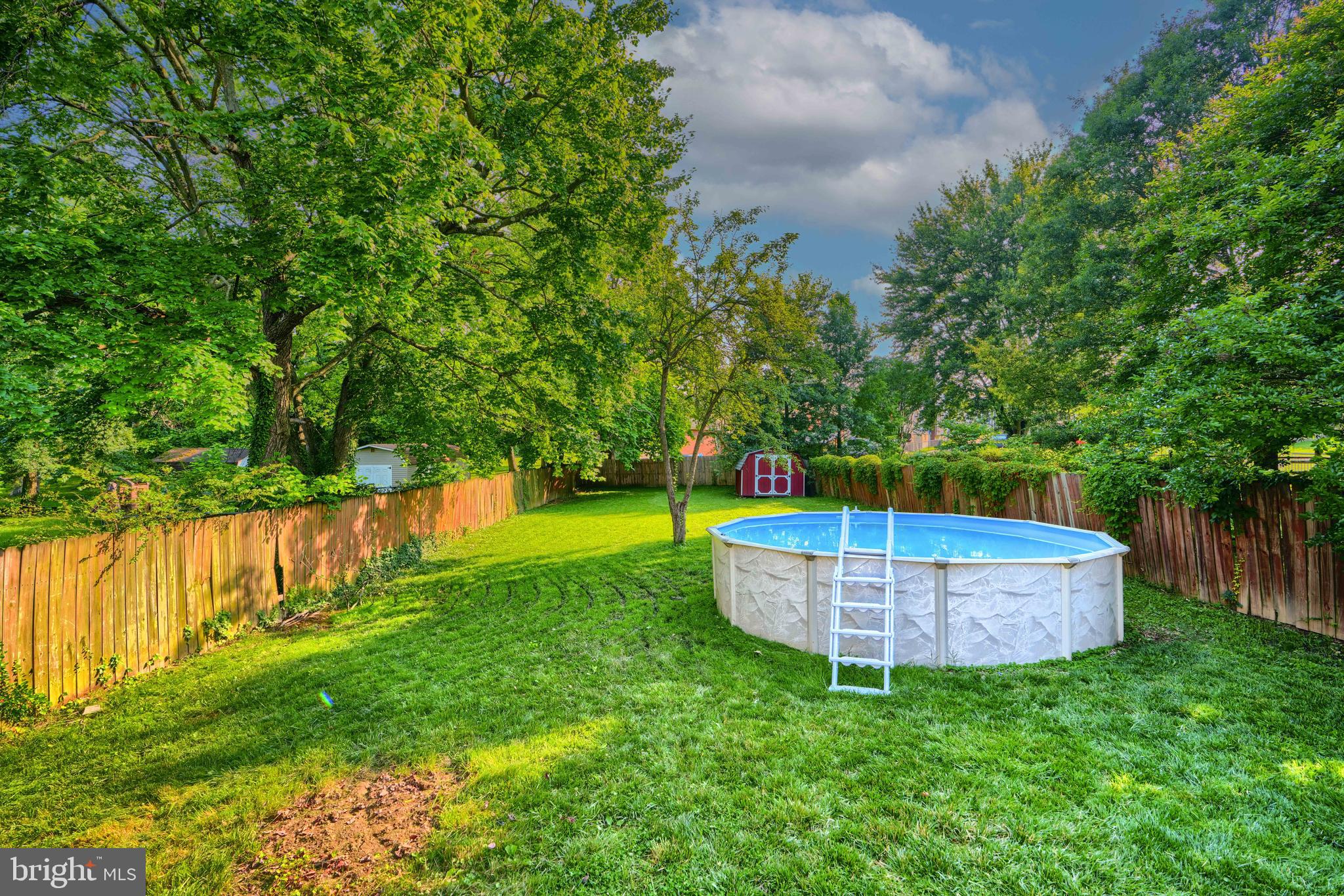 5221 Trumps Mill Road Baltimore, MD 21206 - Photo 41 of 53 a view of a backyard with swimming pool and large trees