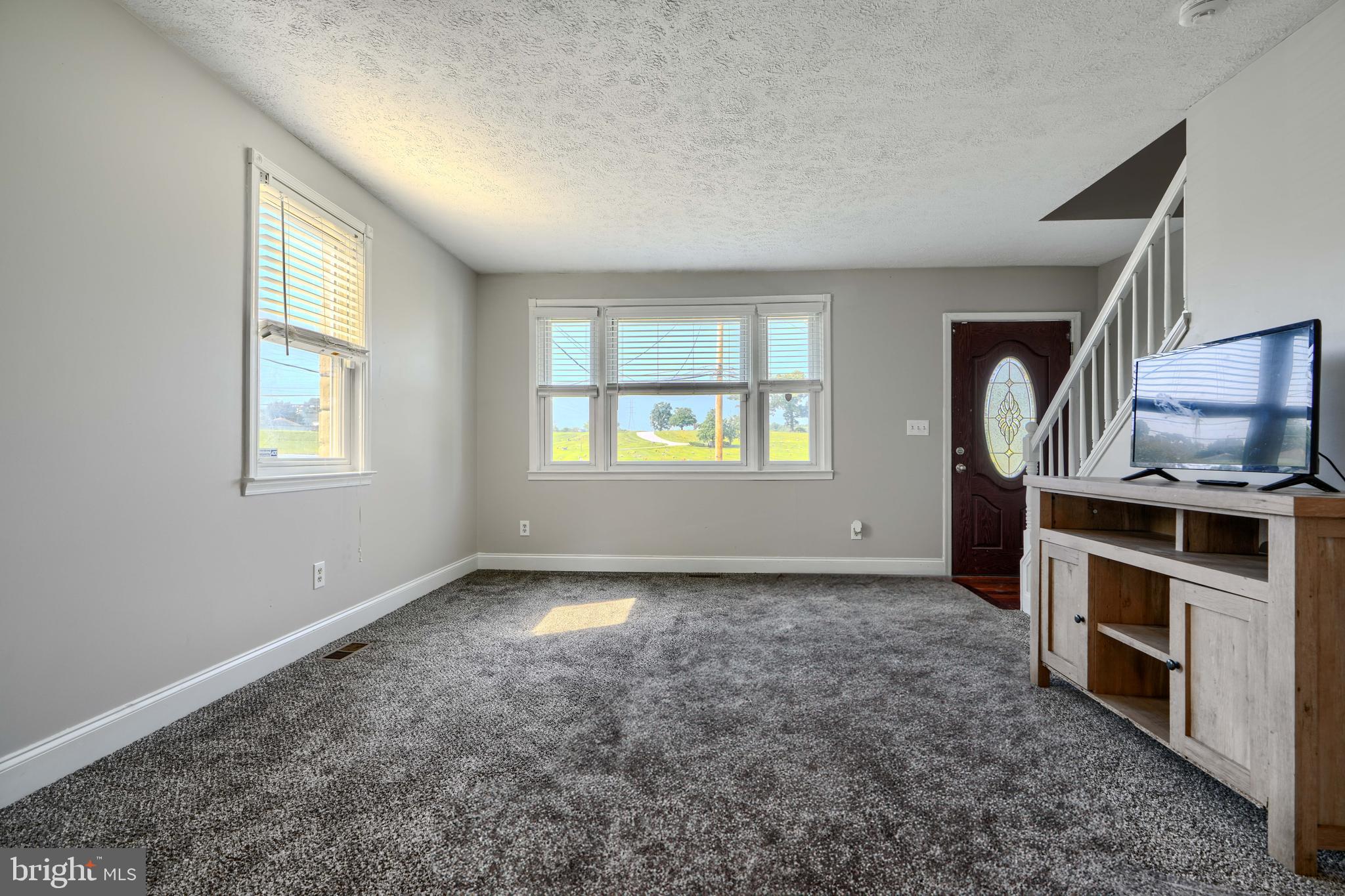 5221 Trumps Mill Road Baltimore, MD 21206 - Photo 7 of 53 wooden floor in an empty room with a window