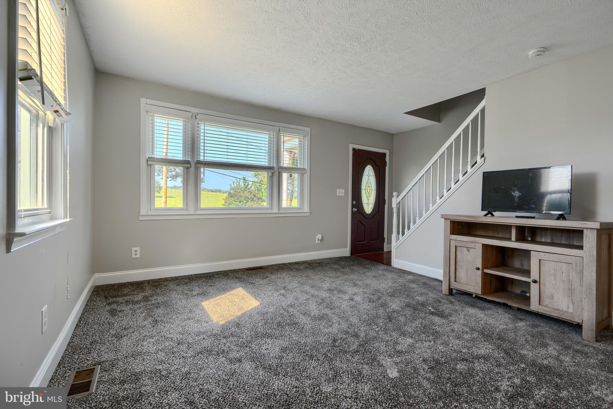 5221 Trumps Mill Road Baltimore, MD 21206 - Photo 8 of 53 a view of an empty room with a window and a kitchen