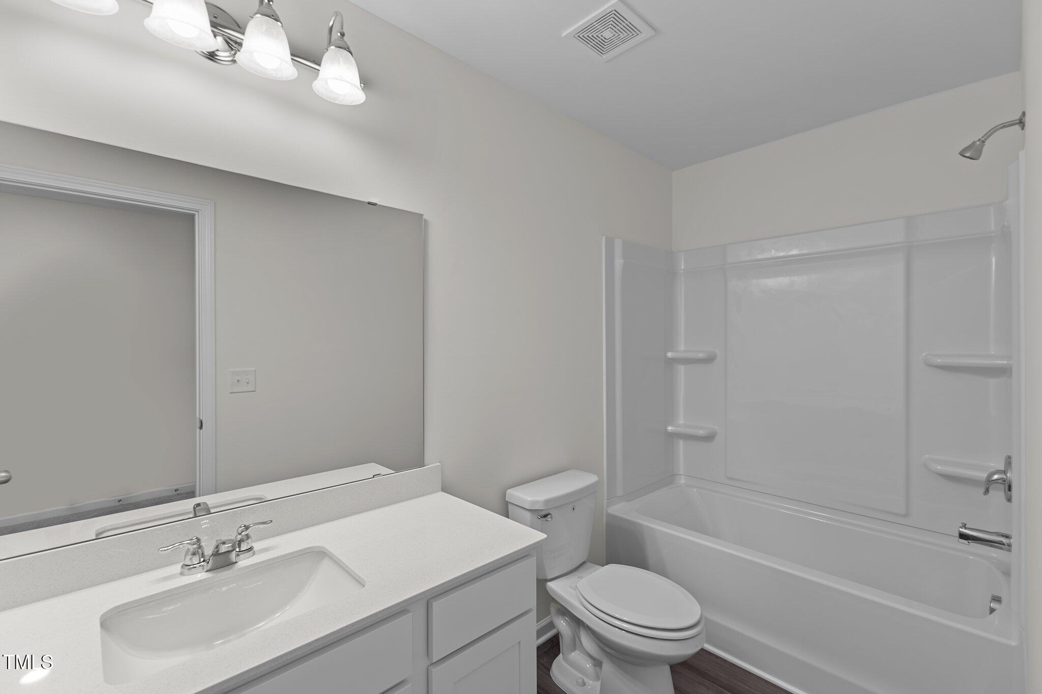 851 Embraer Way Spring Spring Hope, NC 27882 - Photo 15 of 25 a bathroom with a sink a toilet and shower