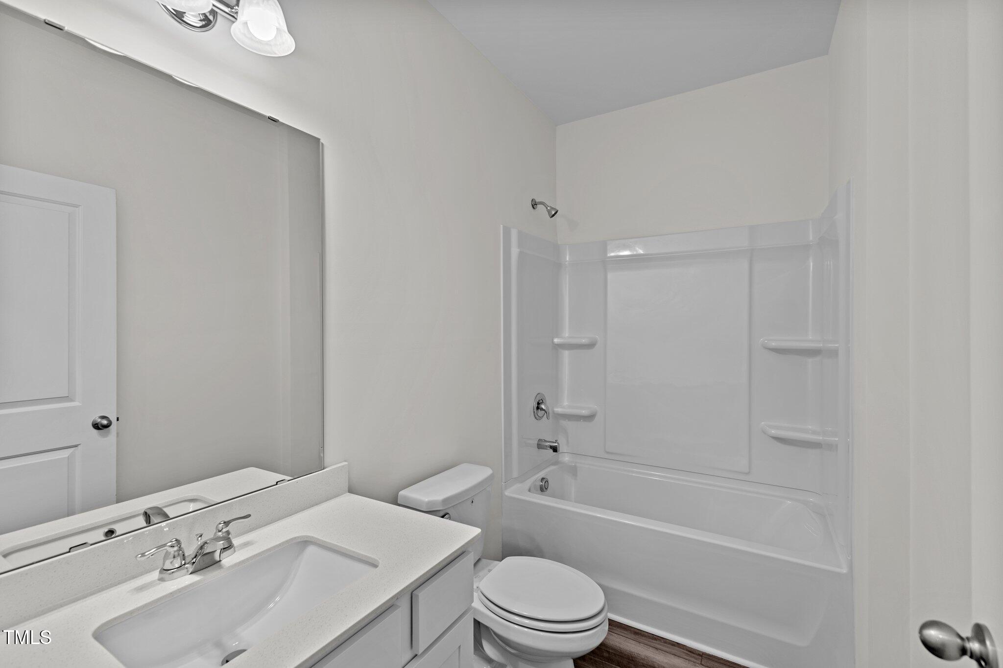 851 Embraer Way Spring Spring Hope, NC 27882 - Photo 7 of 25 a bathroom with a sink toilet vanity and shower