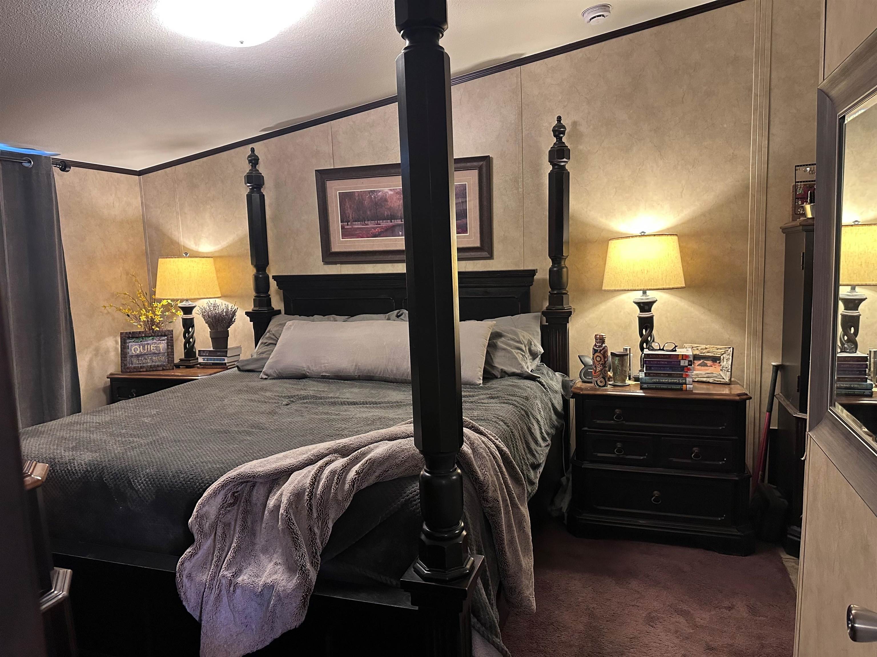 585-25 25 1/2 Road, Unit 125 Grand Junction, CO 81505 - Photo 16 of 24 a bed room with a bed and a lamp
