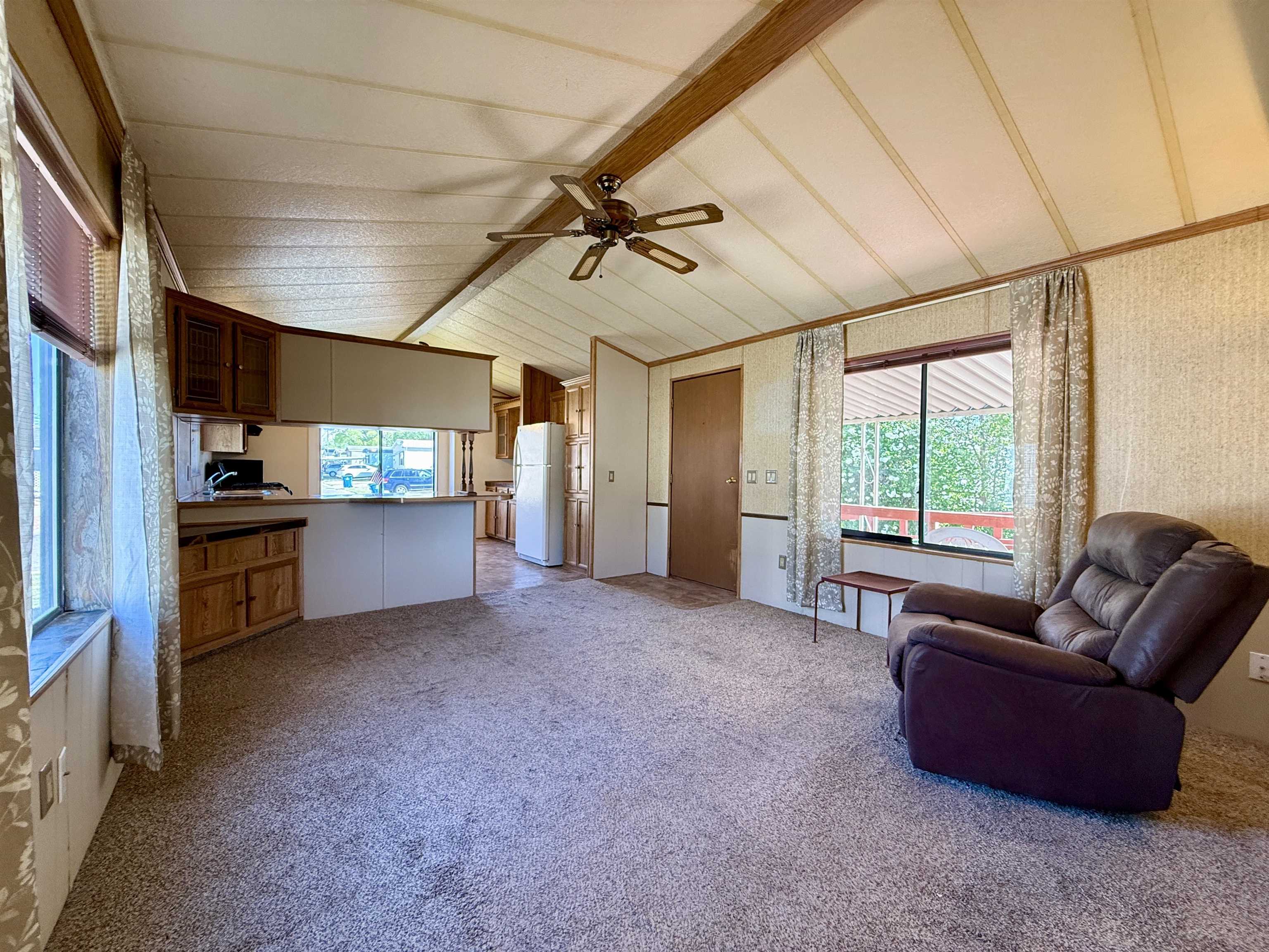 3251 E Road, Unit 33 Clifton, CO 81520 - Photo 13 of 28 a living room with furniture and kitchen view