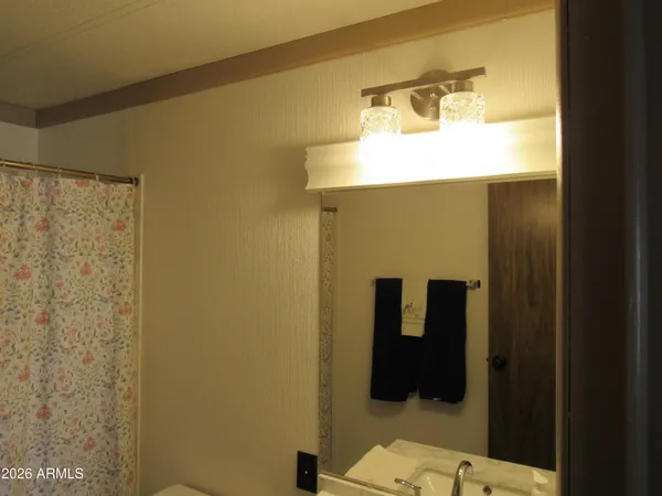 a utility room with wooden floor washer and dryer