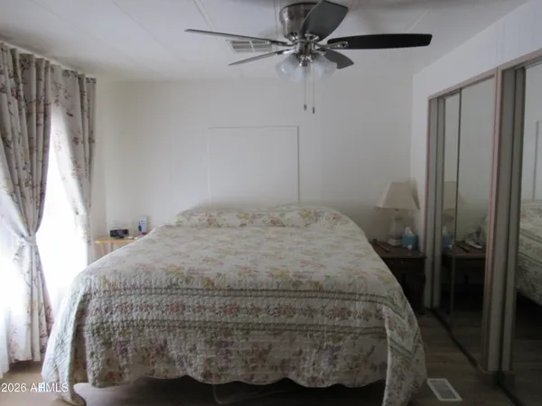 a bedroom with a bed and a chandelier