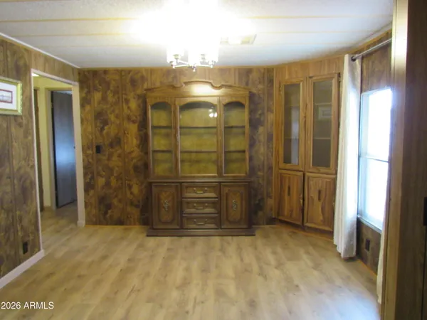 a view of a hallway with a glass door and a bathroom