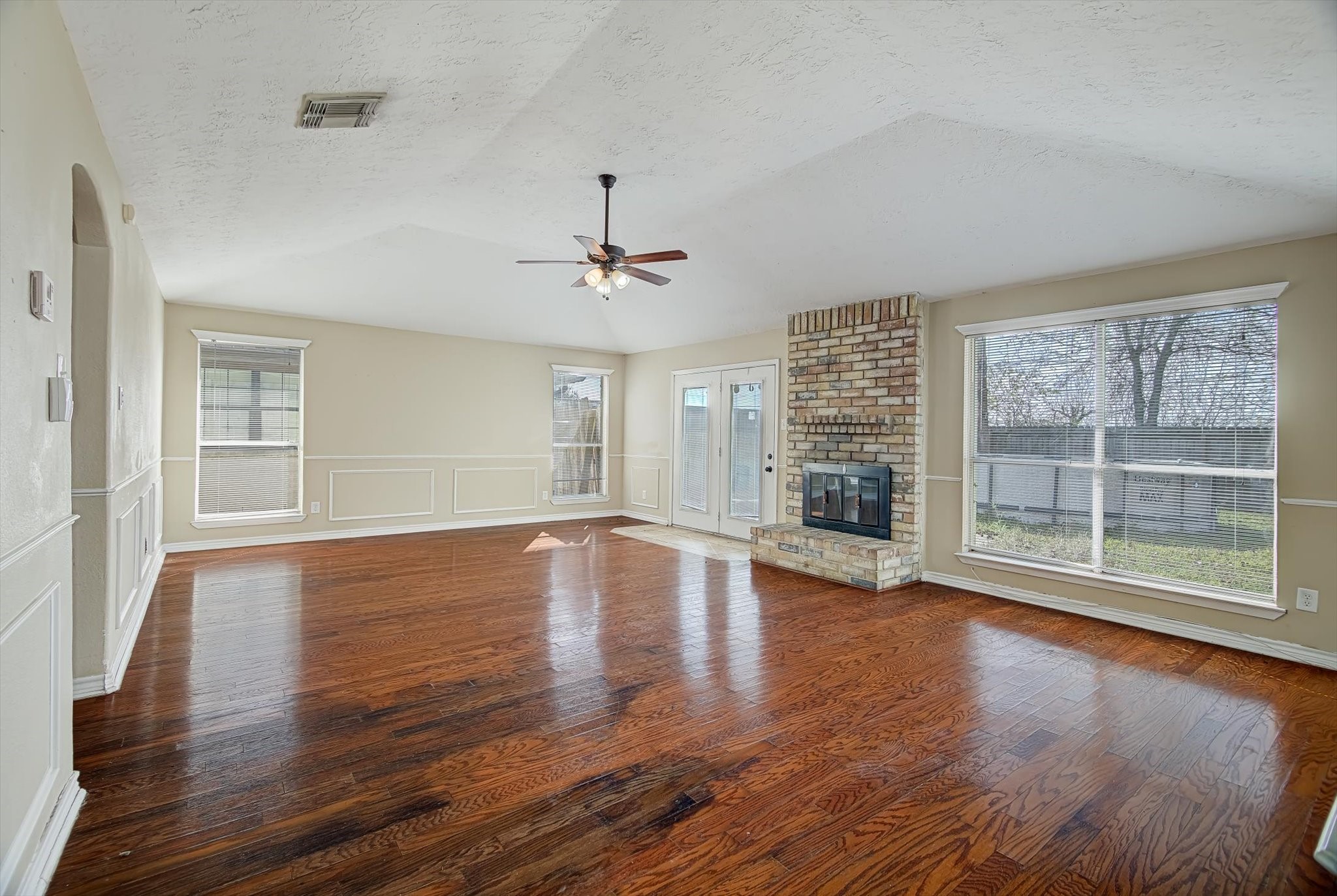 7515 Shoshone Drive Baytown, TX 77521 - Photo 13 of 39 a view of an empty room with wooden floor and a window