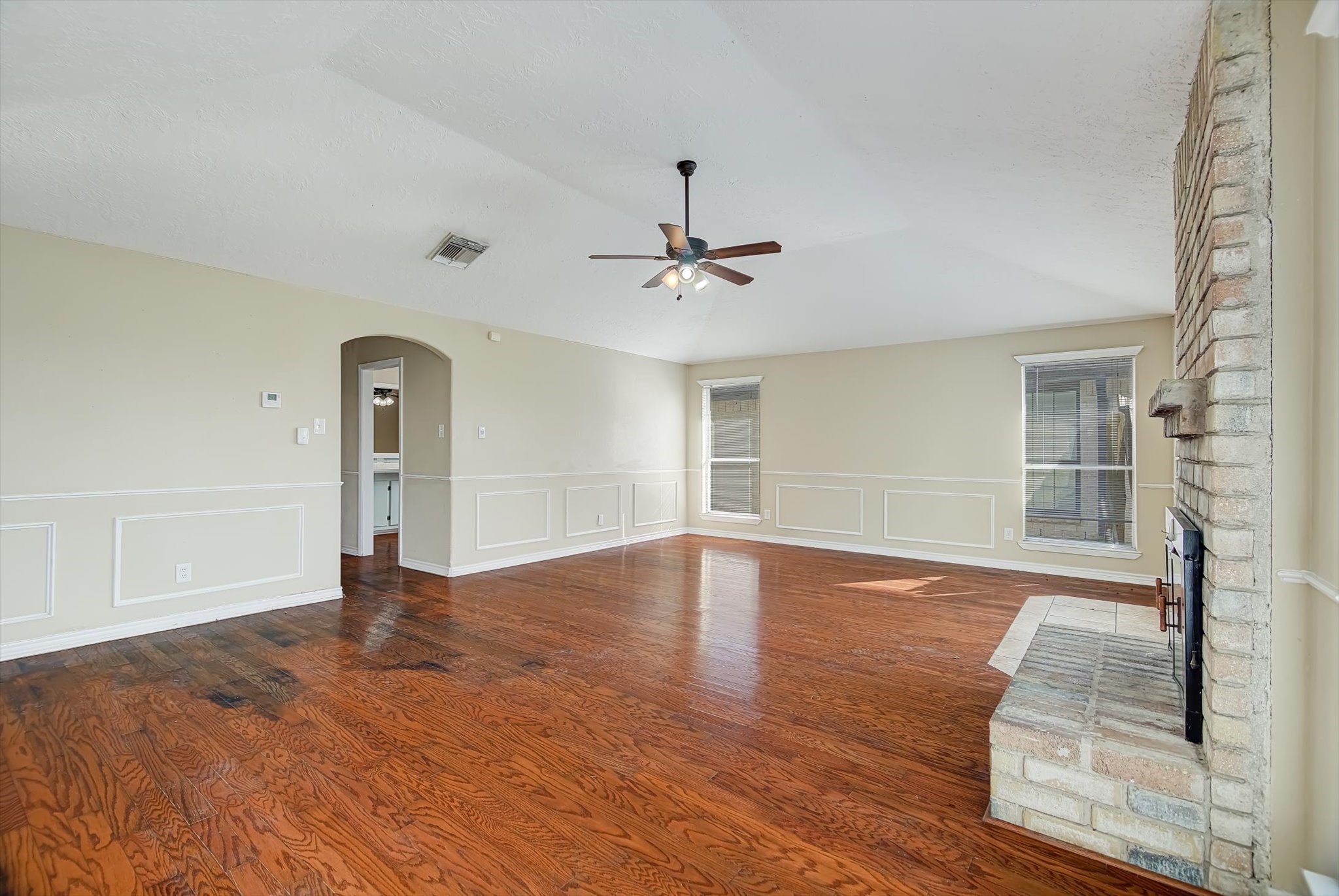7515 Shoshone Drive Baytown, TX 77521 - Photo 14 of 39 wooden floor in an empty room with a window