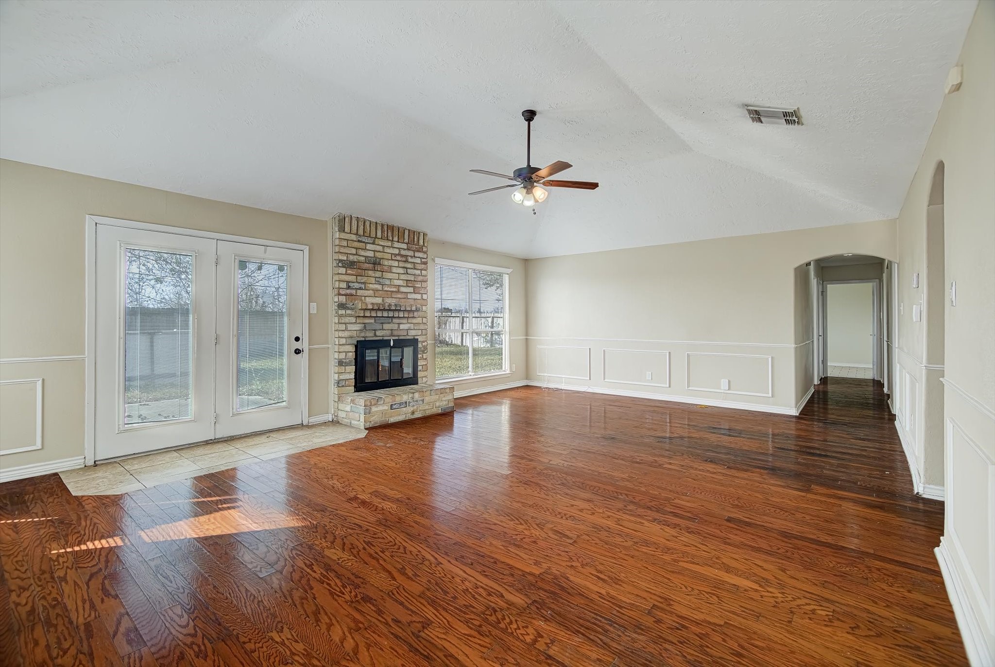 7515 Shoshone Drive Baytown, TX 77521 - Photo 15 of 39 a view of an empty room with wooden floor and a fireplace