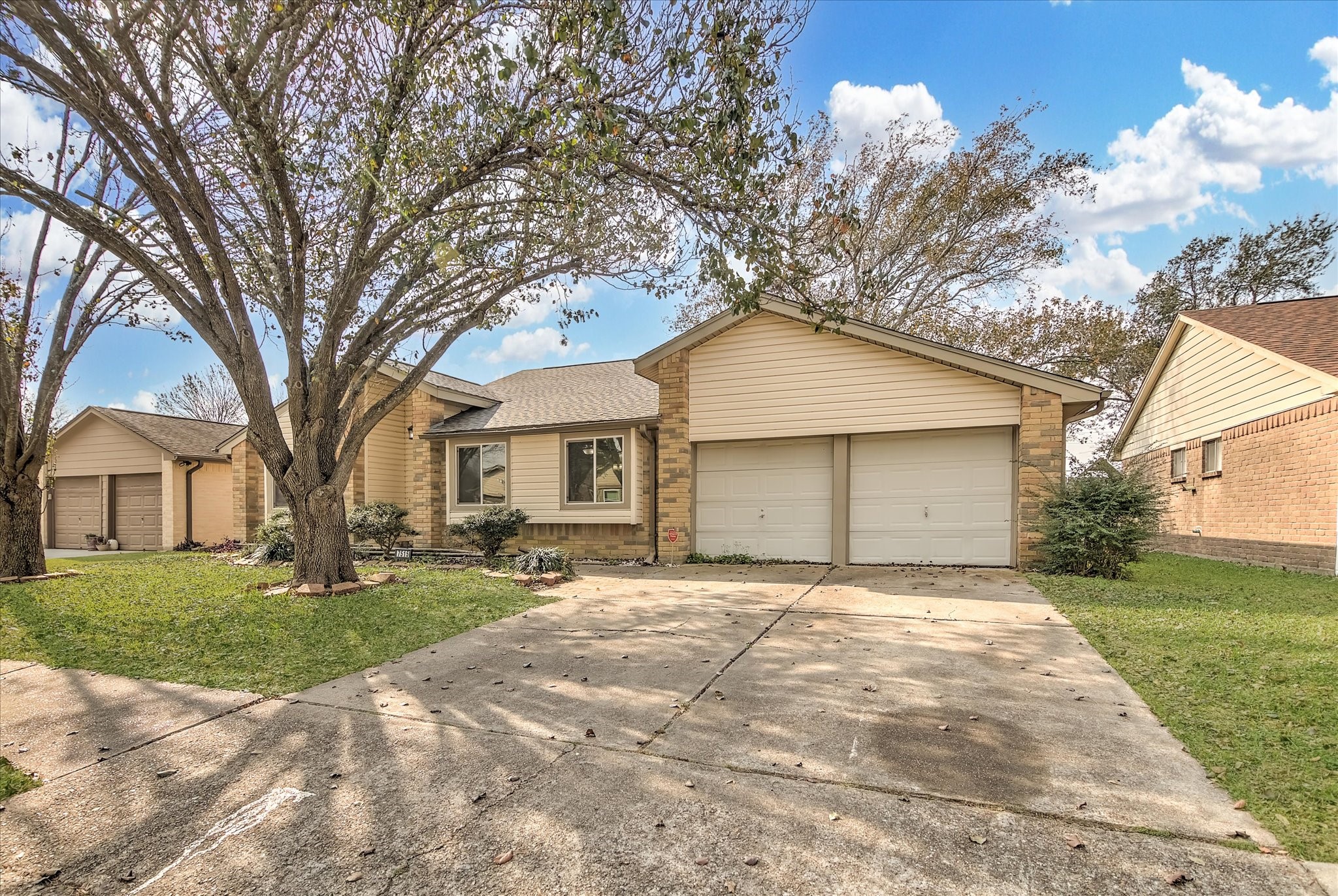 7515 Shoshone Drive Baytown, TX 77521 - Photo 2 of 39 a front view of a house with a yard and trees