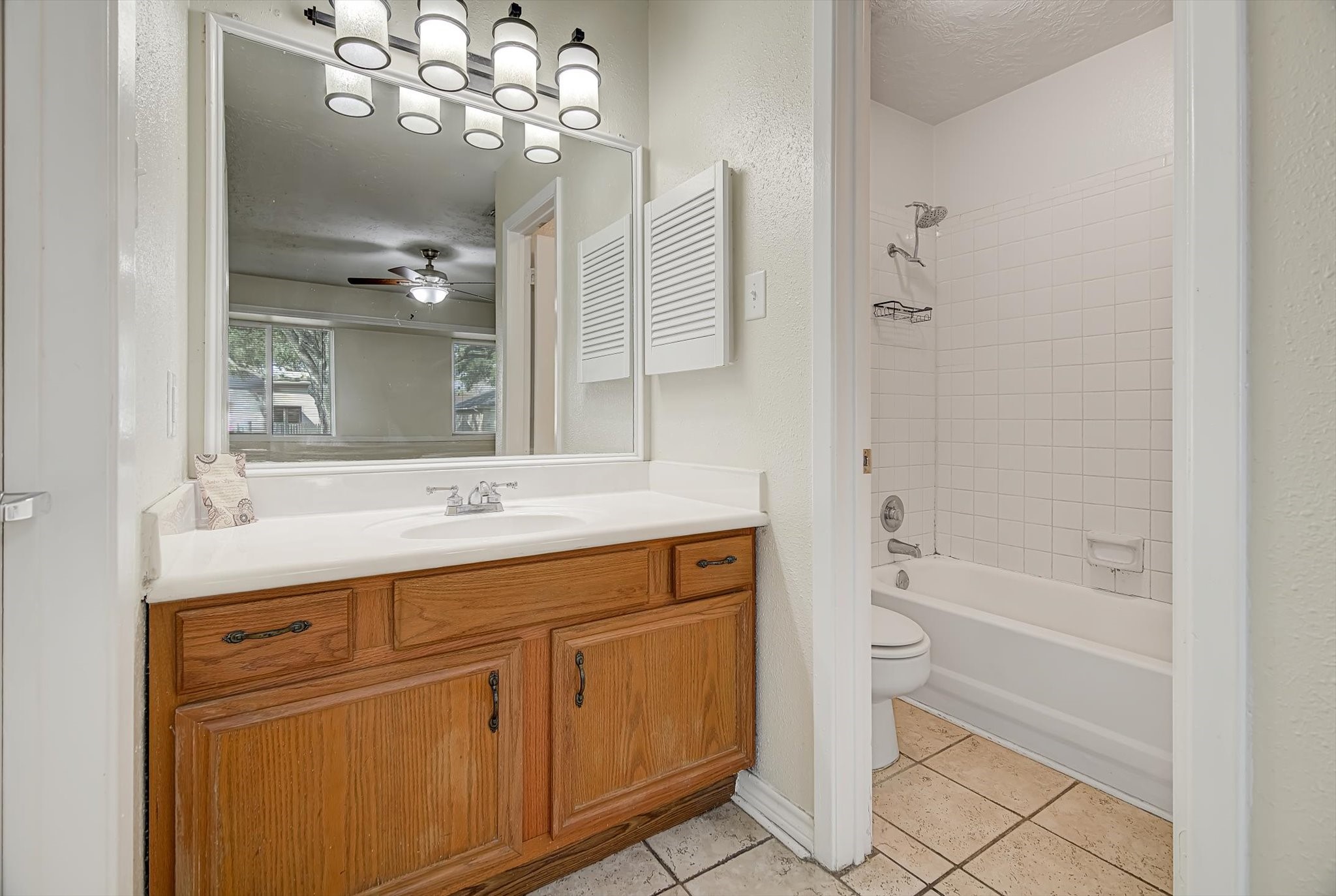 7515 Shoshone Drive Baytown, TX 77521 - Photo 21 of 39 a bathroom with a sink a toilet and shower
