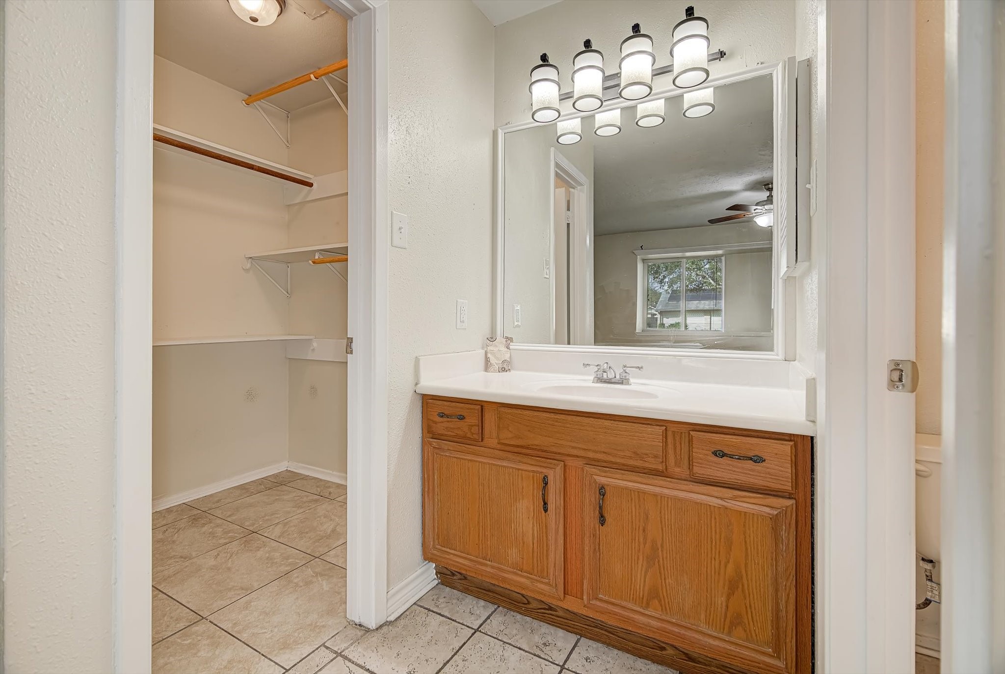 7515 Shoshone Drive Baytown, TX 77521 - Photo 22 of 39 a bathroom with a double vanity sink and a mirror