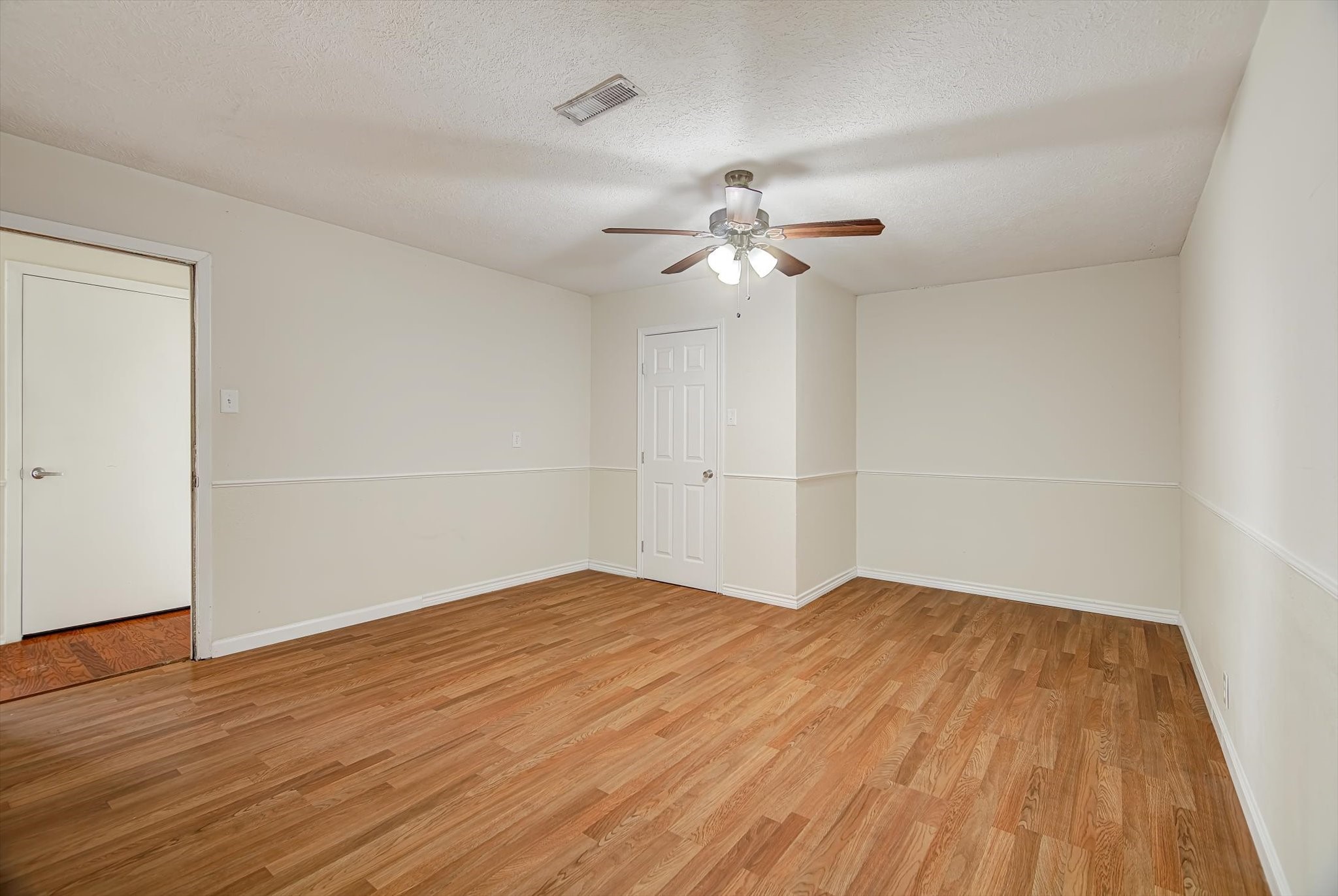 7515 Shoshone Drive Baytown, TX 77521 - Photo 26 of 39 a view of an empty room with wooden floor
