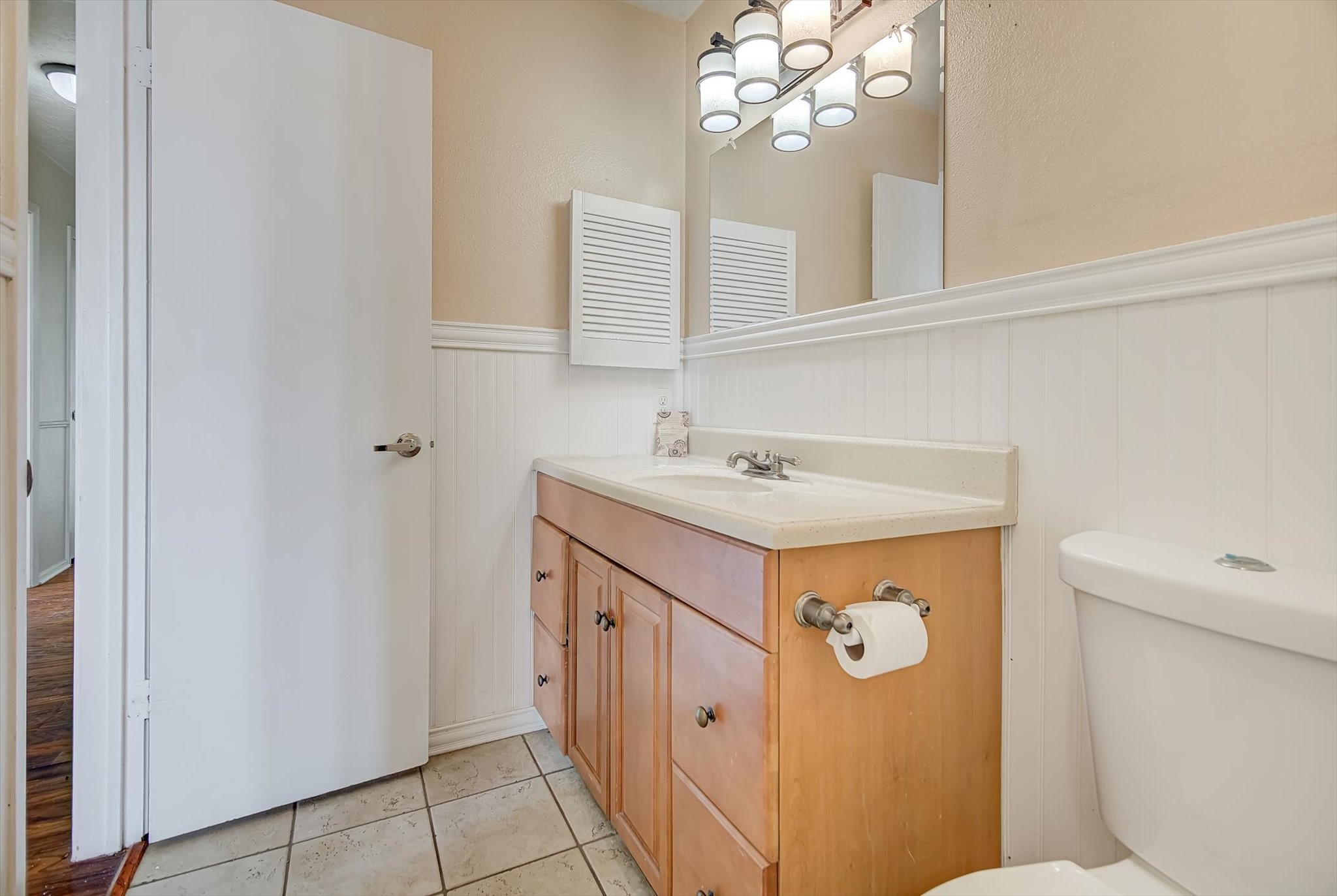 7515 Shoshone Drive Baytown, TX 77521 - Photo 30 of 39 a bathroom with a sink a toilet and a mirror
