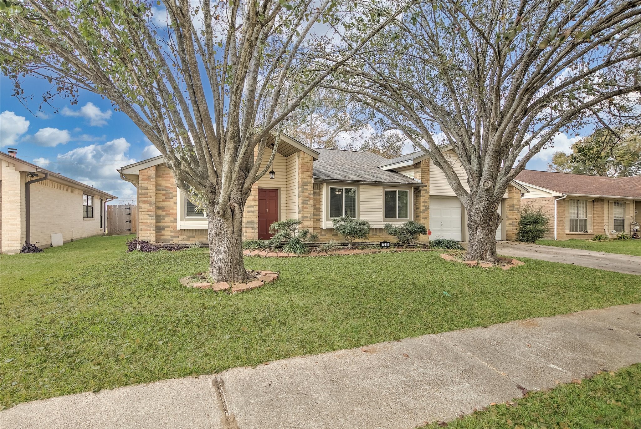 7515 Shoshone Drive Baytown, TX 77521 - Photo 3 of 39 a tree in front of a white house