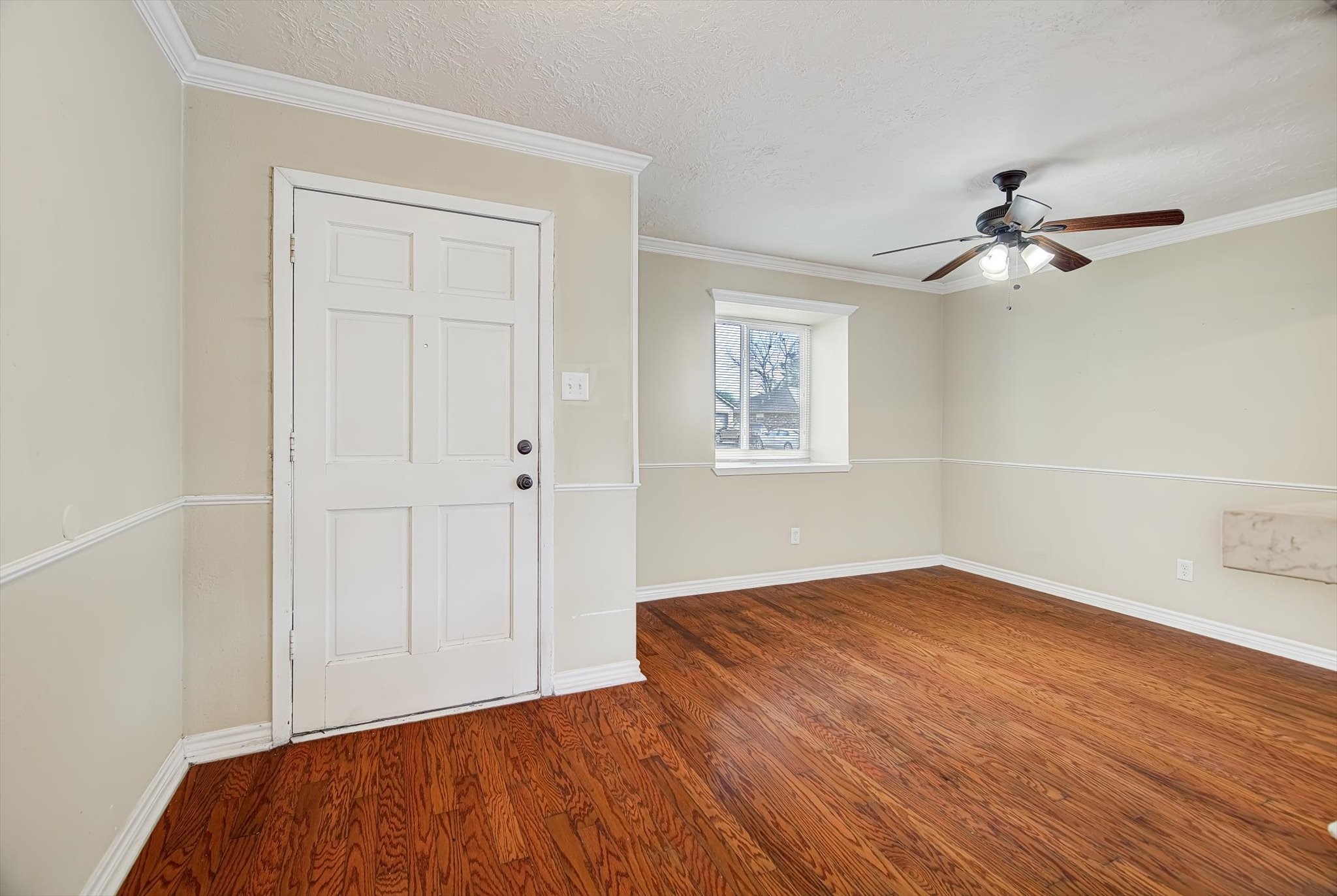 7515 Shoshone Drive Baytown, TX 77521 - Photo 5 of 39 a view of empty room with wooden floor and fan