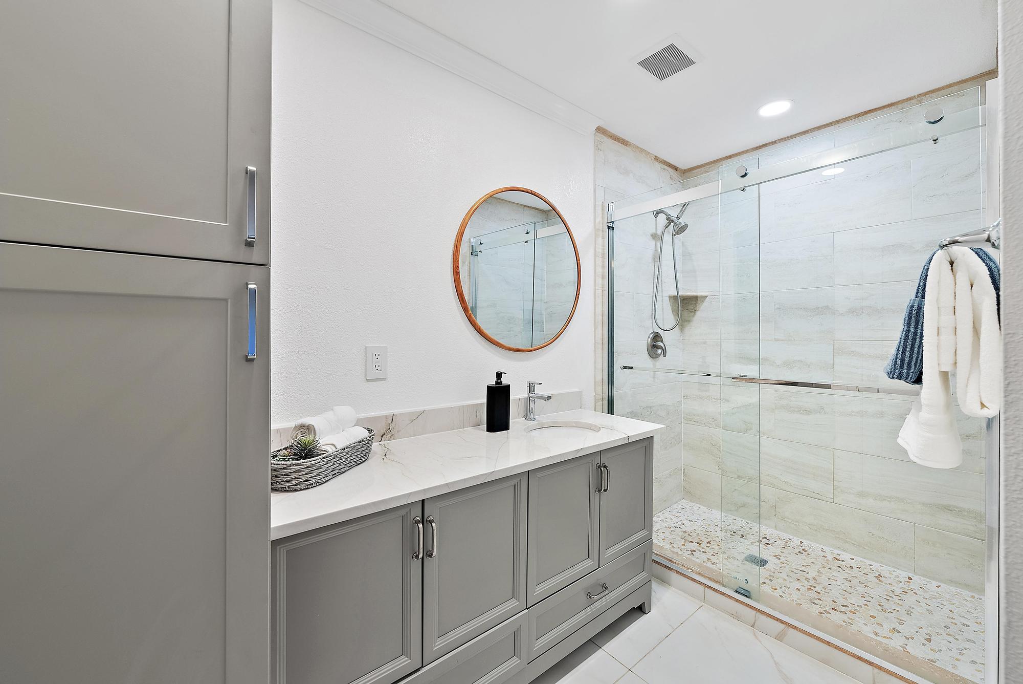 1420 Ocean Way, Unit 30C Jupiter, FL 33477 - Photo 15 of 25 a bathroom with a sink a toilet and shower
