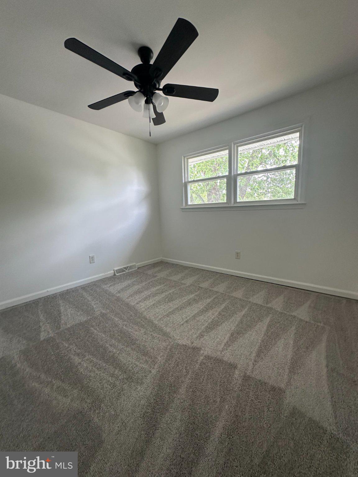 6 Travertine Way Newark, DE 19702 - Photo 21 of 22 an empty room with a ceiling fan and windows