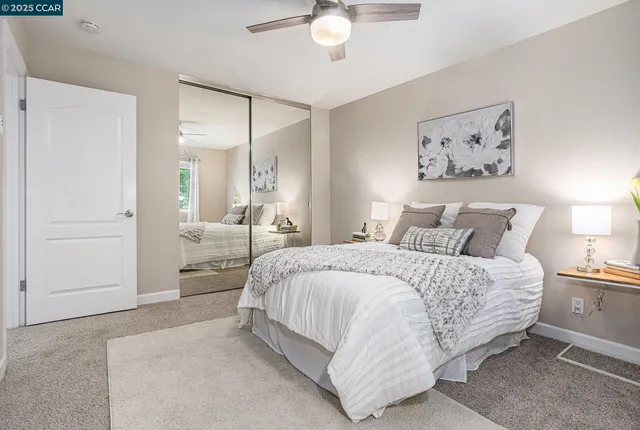 a spacious bedroom with a bed and a chandelier