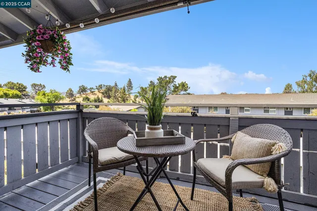 a view of balcony with furniture and a potted plant