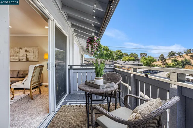a balcony with table and chairs