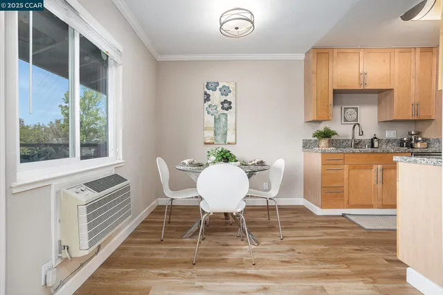 a dining room with furniture a window and wooden floor