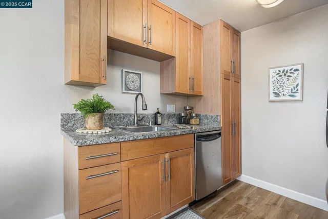 a kitchen with stainless steel appliances granite countertop a sink and cabinets