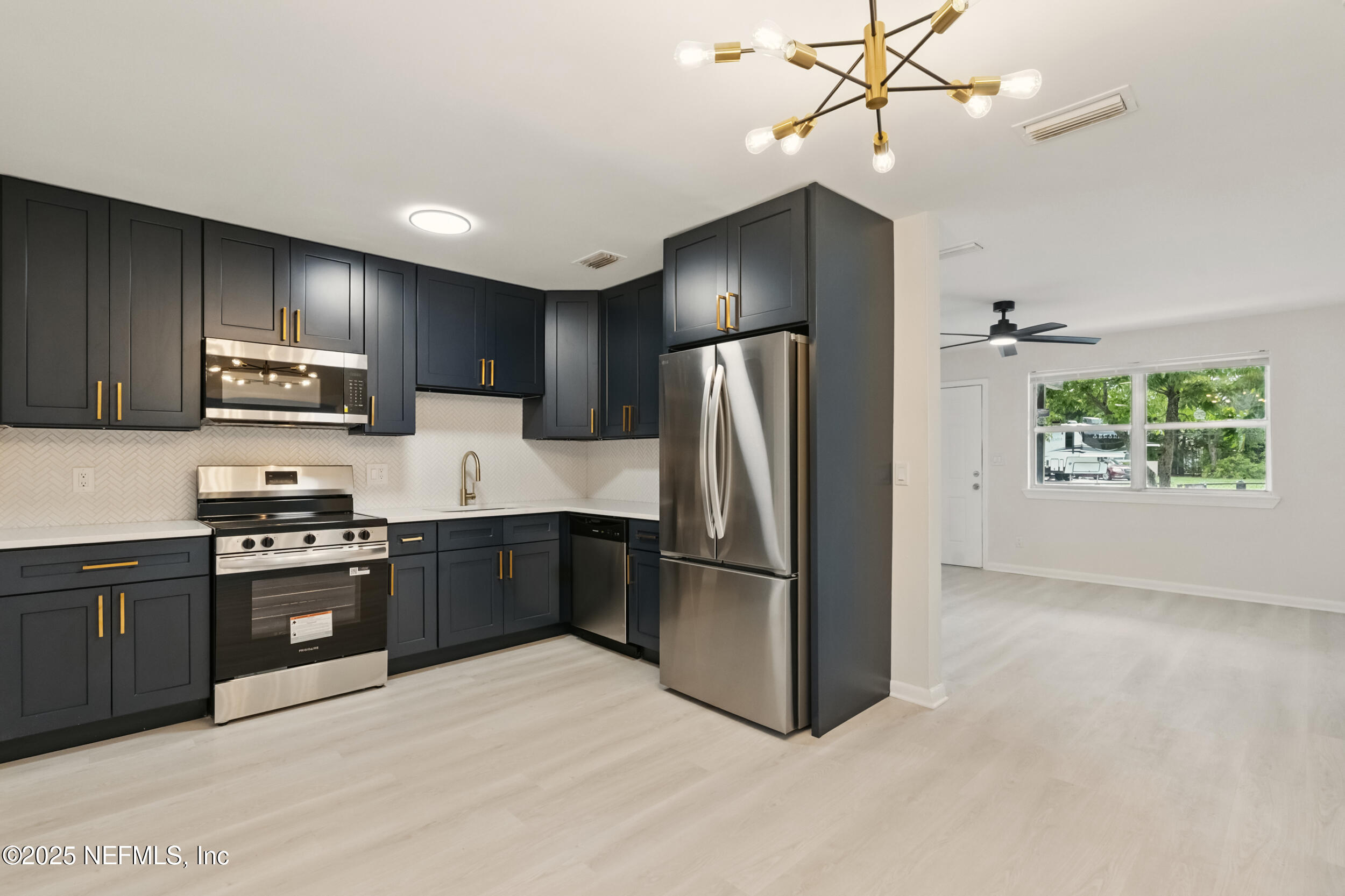3903 Macgregor Drive Jacksonville, FL 32210 - Photo 9 of 49 a kitchen with stainless steel appliances granite countertop a refrigerator microwave and stove