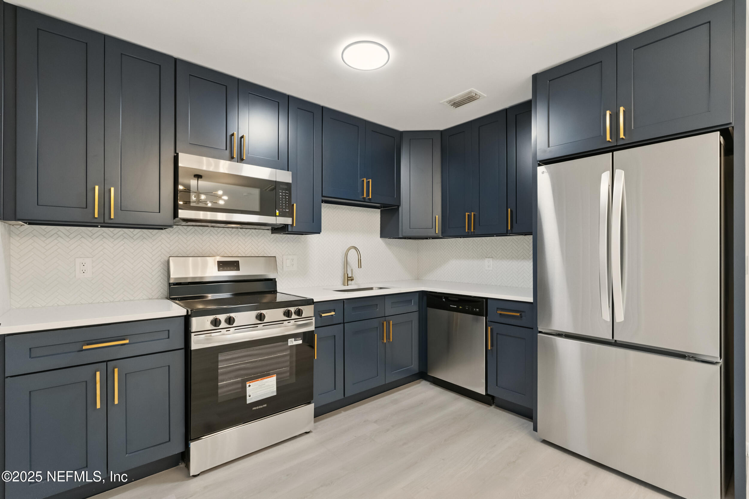 3903 Macgregor Drive Jacksonville, FL 32210 - Photo 10 of 49 a kitchen with stainless steel appliances granite countertop a refrigerator stove a sink dishwasher and microwave