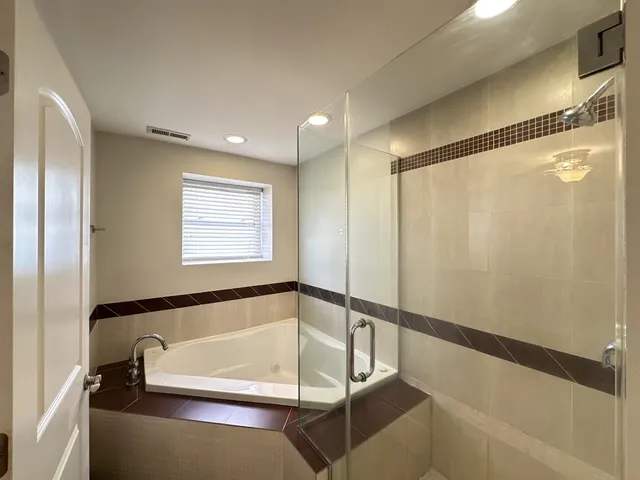 a bathroom with a tub and a shower
