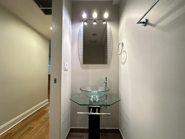 a bathroom with a sink a mirror and shower view