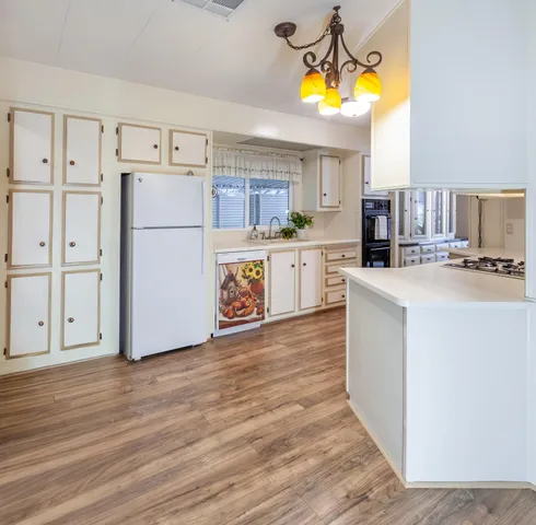 a kitchen with a refrigerator a stove a microwave and cabinets