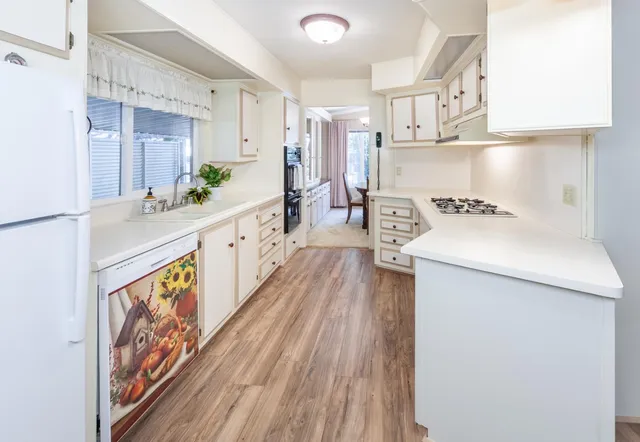 a kitchen with a sink stove and wooden cabinets