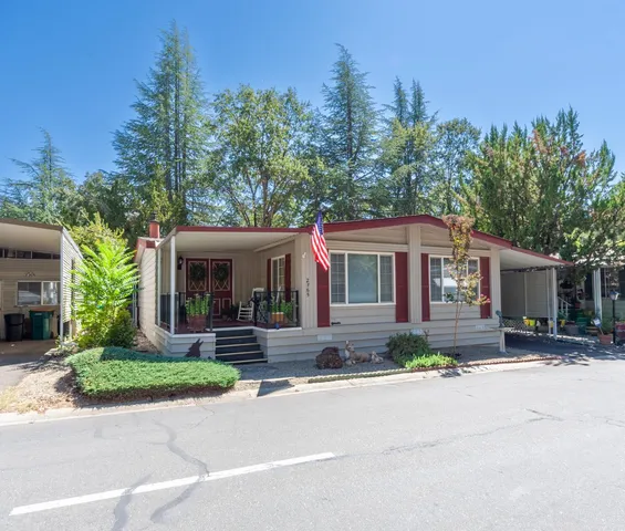 a front view of a house with a yard and outdoor seating