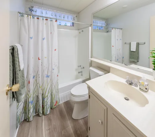 a spacious bathroom with a sink a toilet and shower