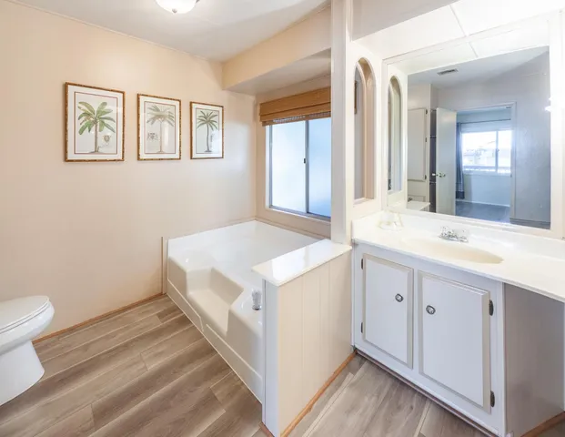 a large white kitchen with a sink and dish washer