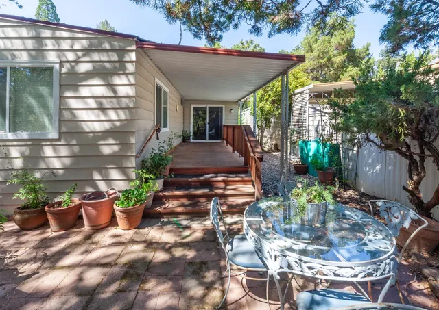 a view of a house with backyard and sitting area