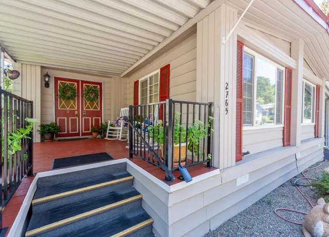 a balcony with stairs and wooden floor